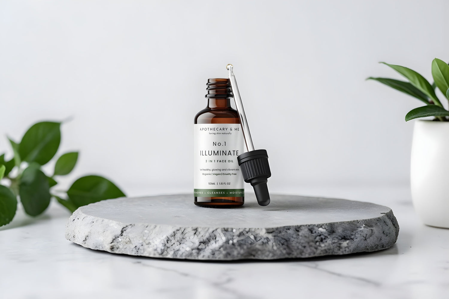 Apothecary & Me No.1 Illuminate Face Oil with dropper open, displayed on a stone platform surrounded by green plants, a natural fragrance-free face oil for soothing menopausal skin rashes and irritation