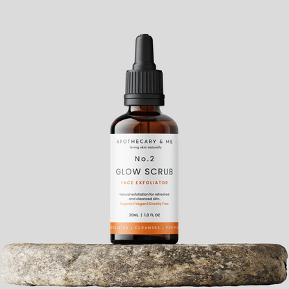 Bottle of Apothecary &amp; Me No. 2 Glow Scrub on a gray background